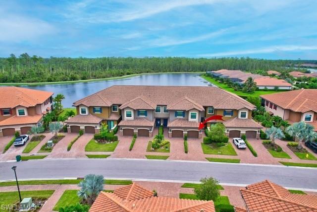 Aerial view of building and surrounding neighborhood area featuring wide lake and preserve views