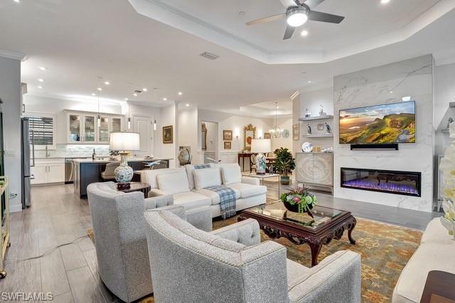 View of remote electric linear fireplace, kitchen, and dining room area.