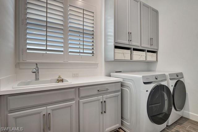 Laundry room featuring washer and dryer, porcelain would like tile  floors.