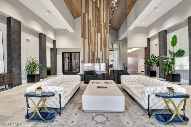 Community lobby featuring high vaulted ceiling, wood ceiling, and recessed lighting