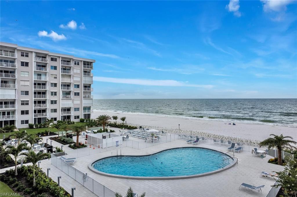 Community pool with view of water and beach