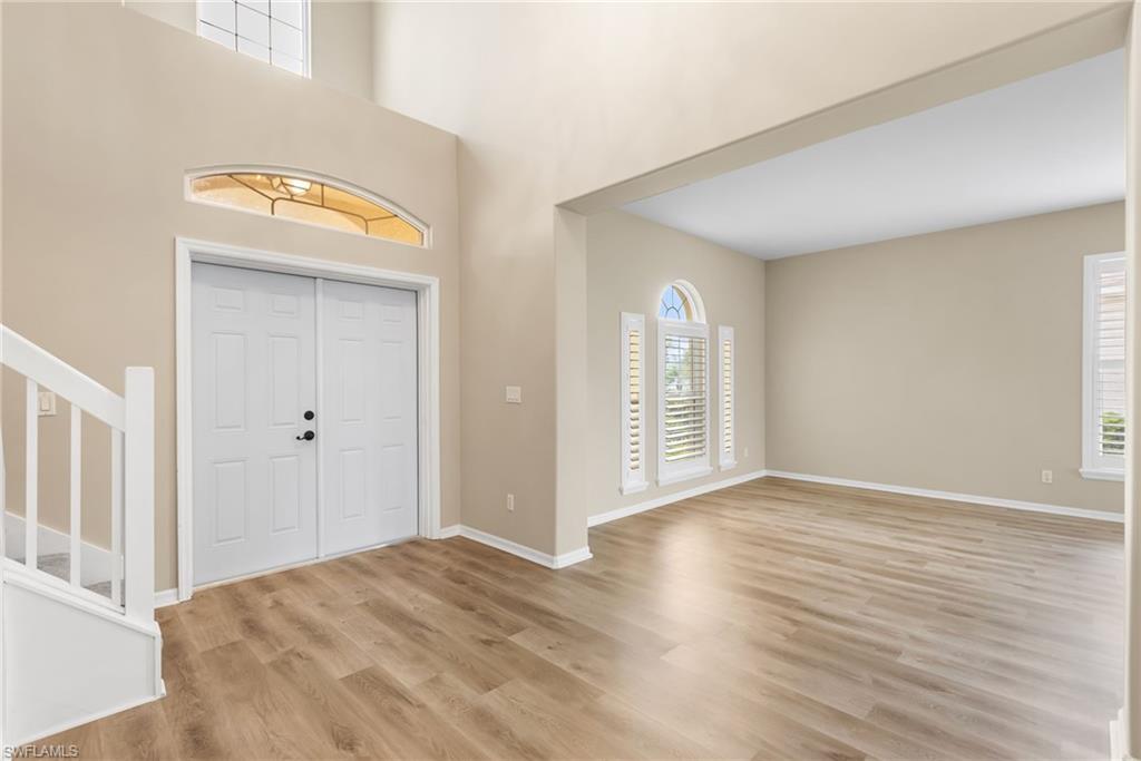As you enter this beautiful home the soaring ceilings and the new luxury vinyl floors welcome you in! Plantation shutters and hurricane impact windows throughout!