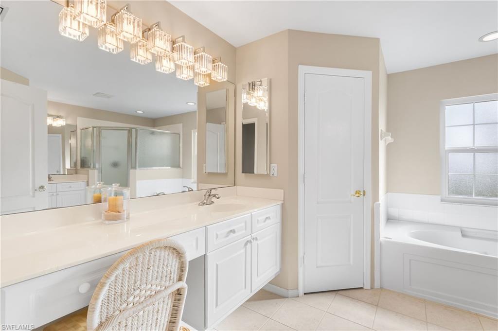 Your spacious primary bathroom offers separate vanities and a dressing area. Garden tub and a separate walk in shower.