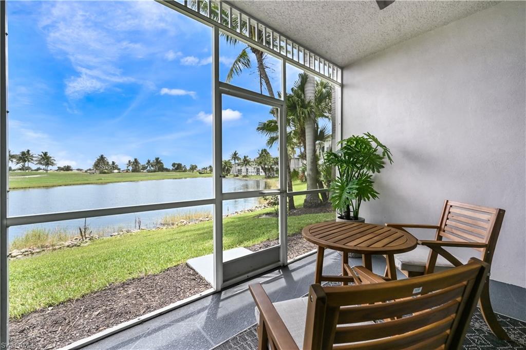 Sunroom featuring a water view