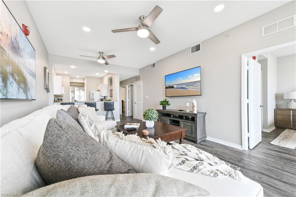 Living area with wood finished floors, recessed lighting, and a ceiling fan