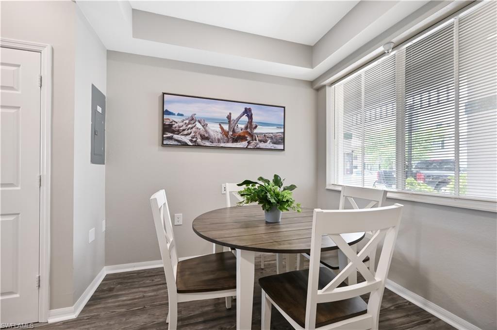 Dining area featuring dark wood finished floors and electric panel