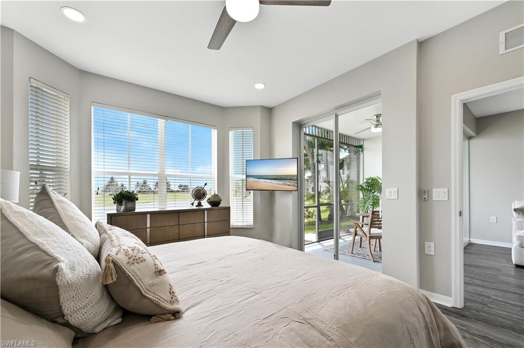 Bedroom with access to exterior, wood finished floors, a ceiling fan, and recessed lighting