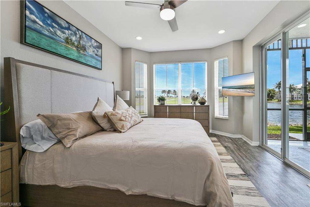 Bedroom with access to exterior, wood finished floors, multiple windows, ceiling fan, and recessed lighting