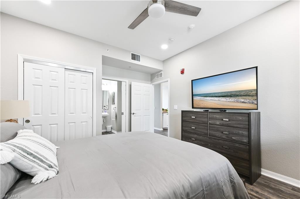 Bedroom with dark wood-type flooring, ceiling fan, a closet, ensuite bathroom, and recessed lighting