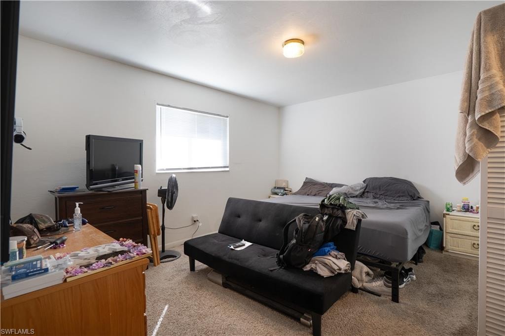 Bedroom featuring light colored carpet