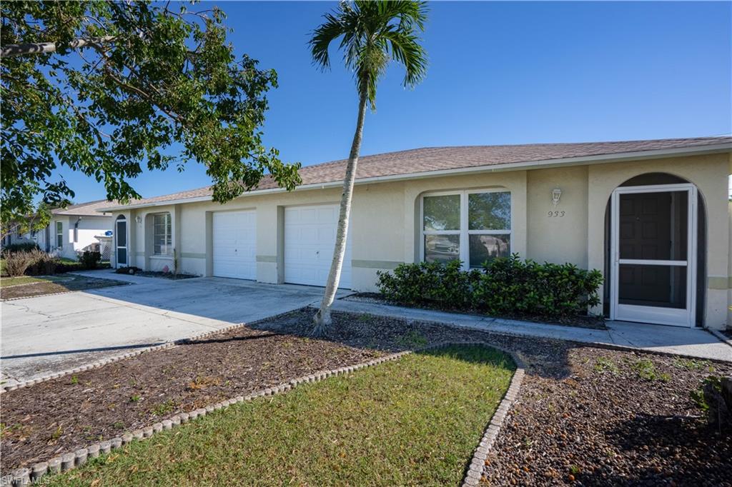 Ranch-style home featuring stucco siding, concrete driveway, an attached garage, and roof with shingles