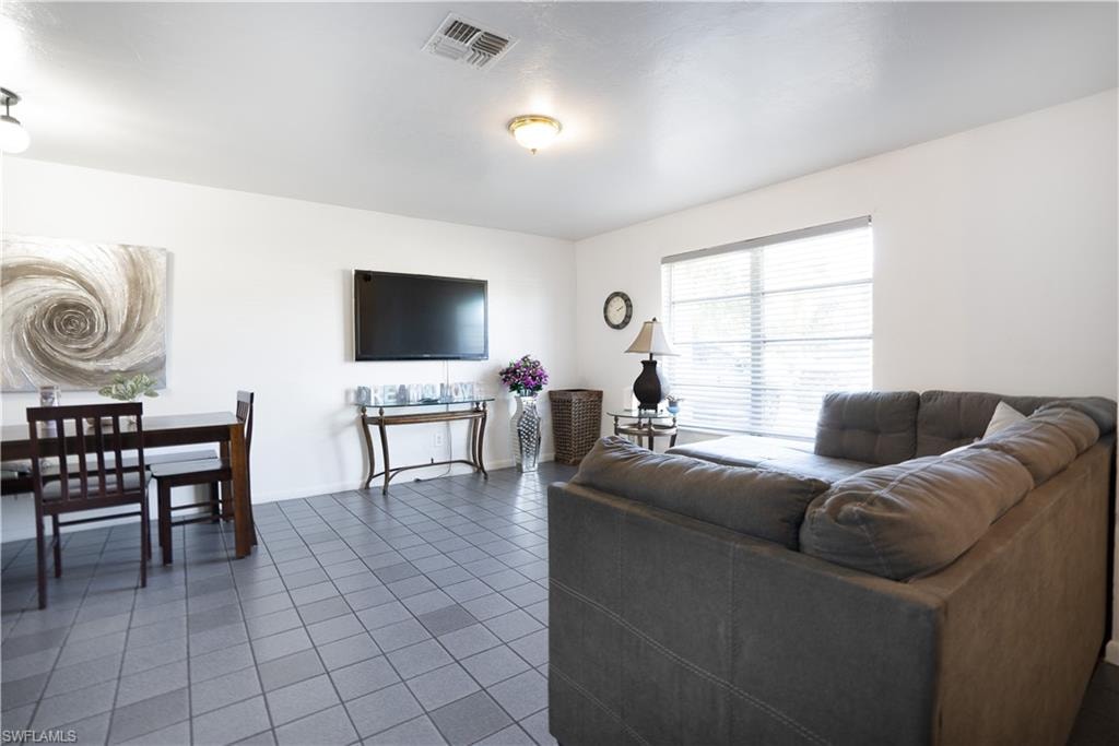 Living area featuring tile patterned flooring and baseboards