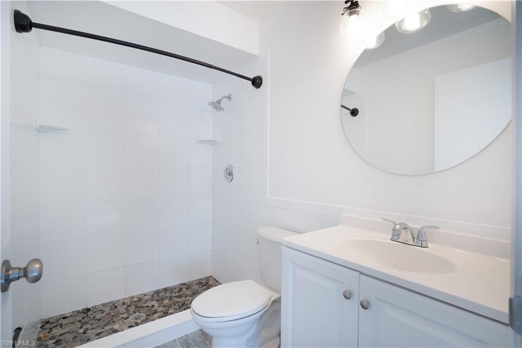 Bathroom with vanity and tiled shower