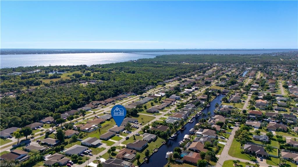 Aerial perspective of suburban area with a nearby body of water