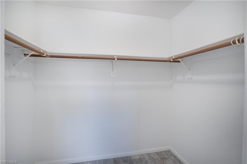 Walk in closet featuring light wood-style flooring