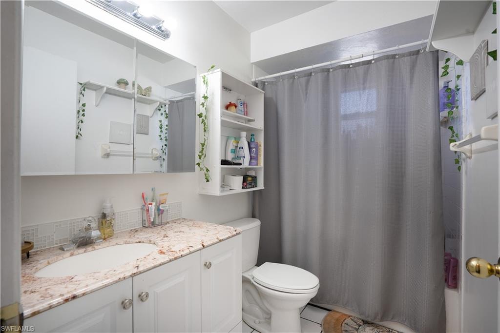 Full bathroom featuring vanity and toilet