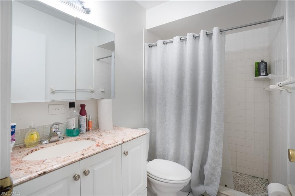 Bathroom featuring a shower stall and vanity