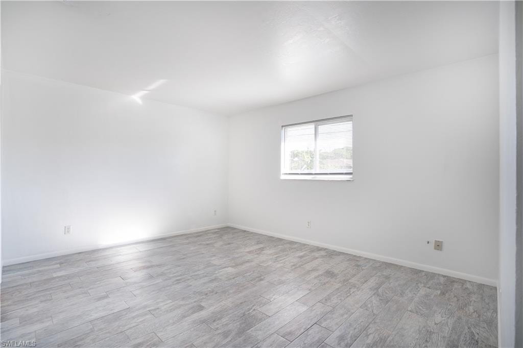 Spare room with wood finished floors and baseboards
