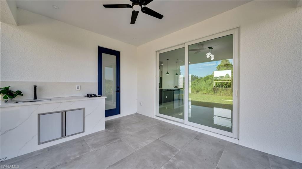 View of patio with an outdoor kitchen and a ceiling fan