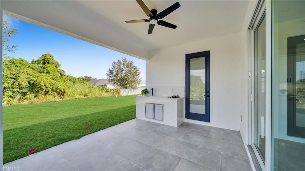 View of patio / terrace featuring ceiling fan and exterior kitchen