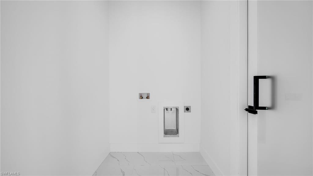 Washroom featuring marble finish flooring, hookup for a washing machine, and electric dryer hookup