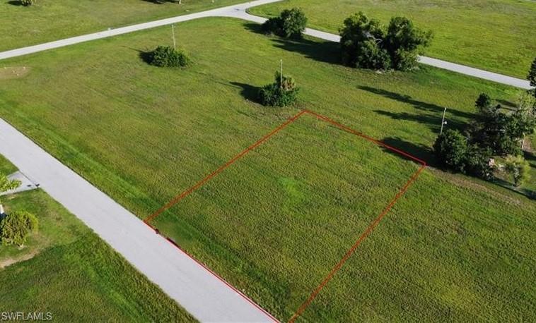 Aerial view of property and surrounding area featuring property boundaries highlighted