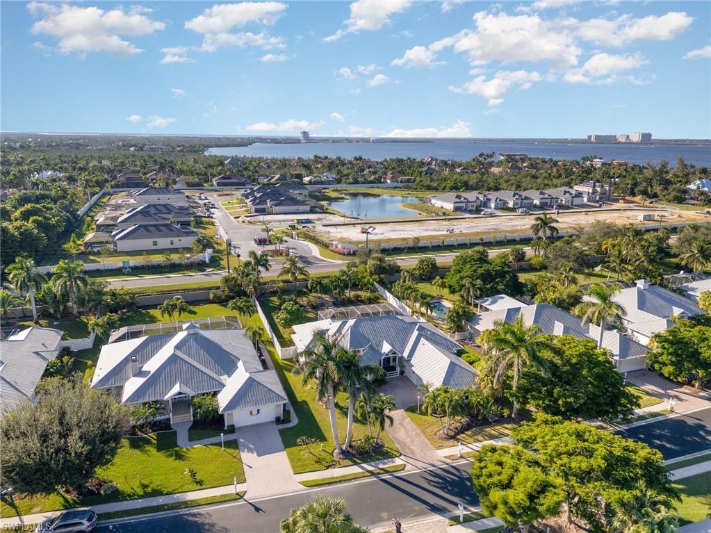 Aerial perspective of suburban area featuring a large body of water