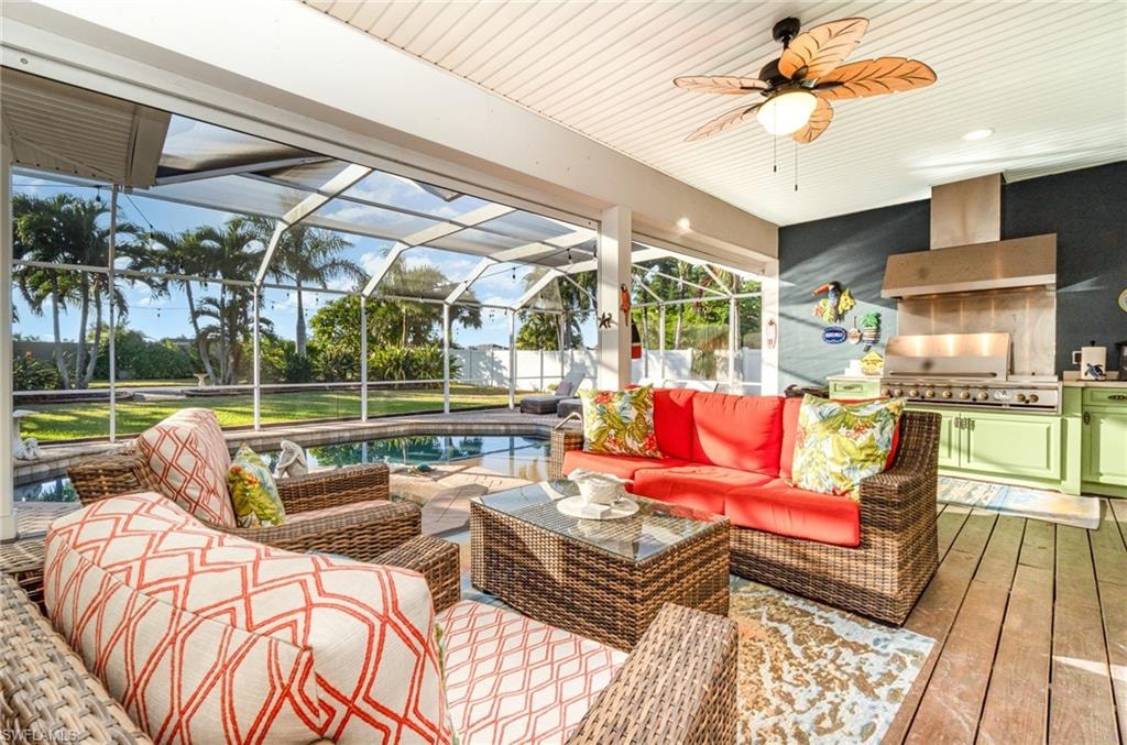 Sunroom / solarium with area for grilling, a ceiling fan, a patio, and outdoor lounge area