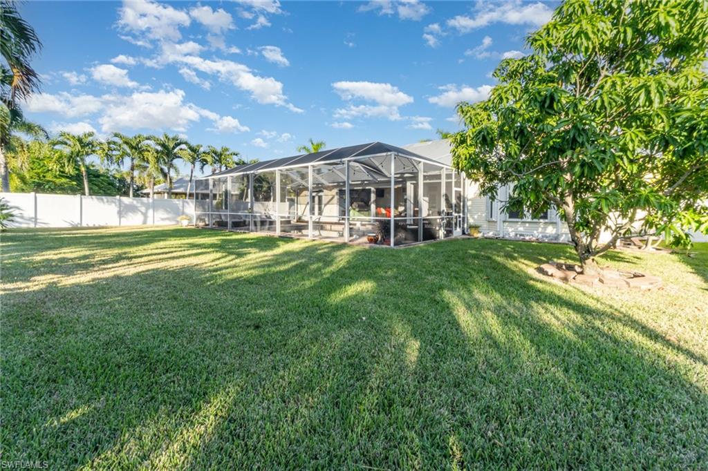 Back of property with glass enclosure and a sunroom