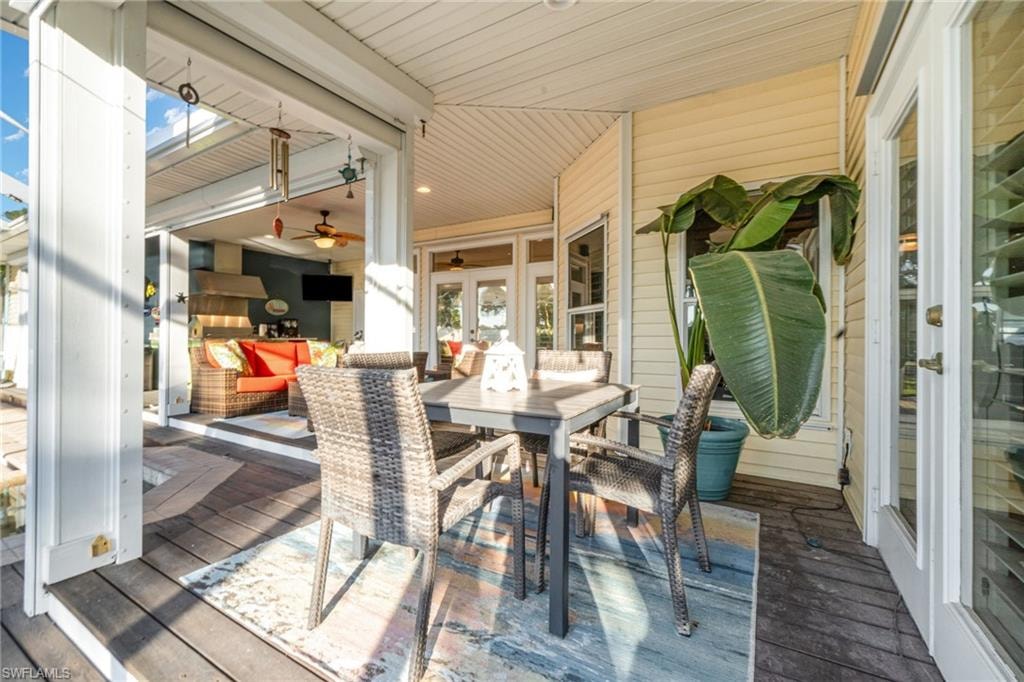 Deck featuring outdoor dining space and french doors