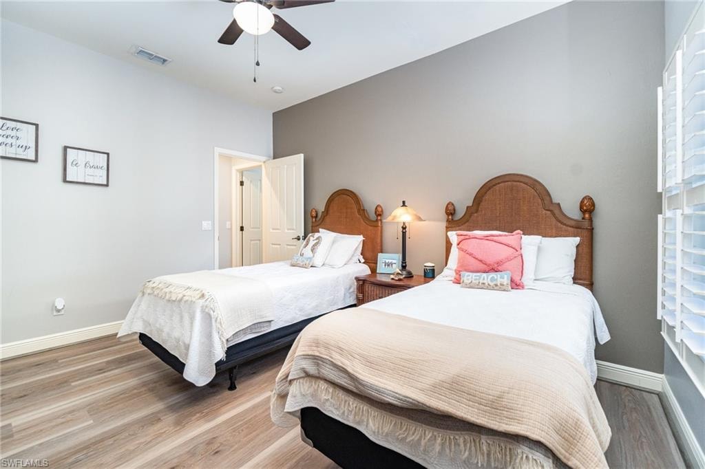 Bedroom with wood finished floors and a ceiling fan