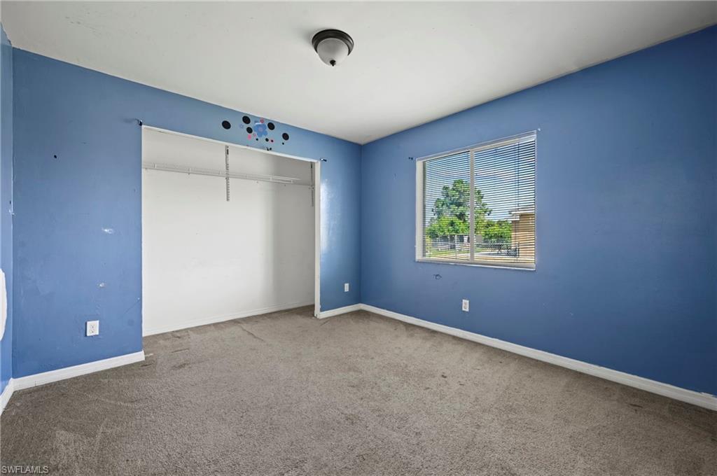 Unfurnished bedroom featuring carpet flooring and a closet