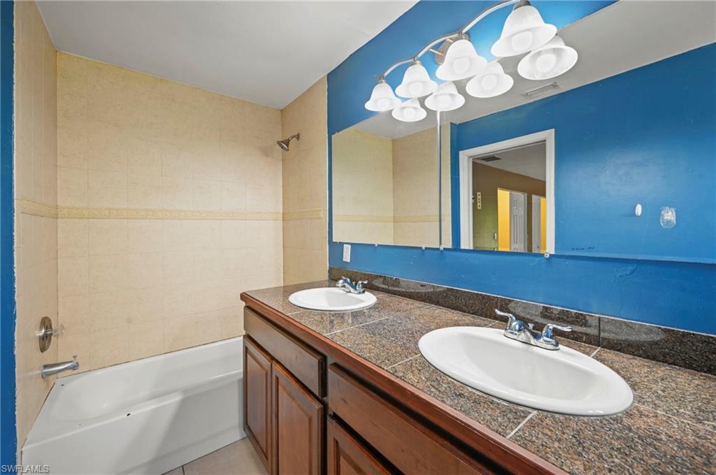 Bathroom with shower / tub combination and double vanity