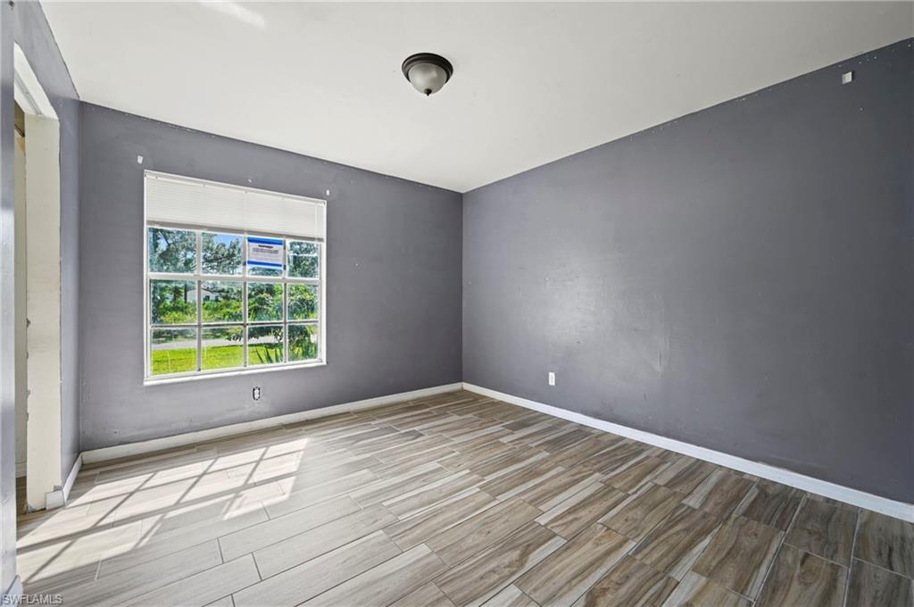Empty room with wood tiled floors and baseboards
