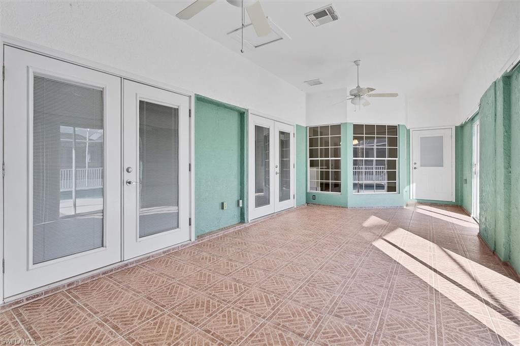 View of patio / terrace with ceiling fan, french doors, and a sunroom