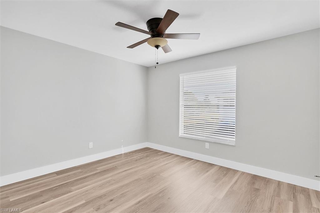 Spare room with light wood-style floors and a ceiling fan