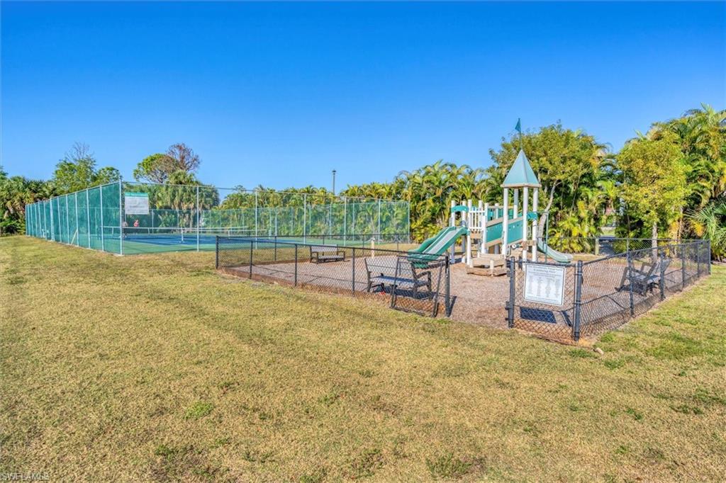Community playground with a tennis court