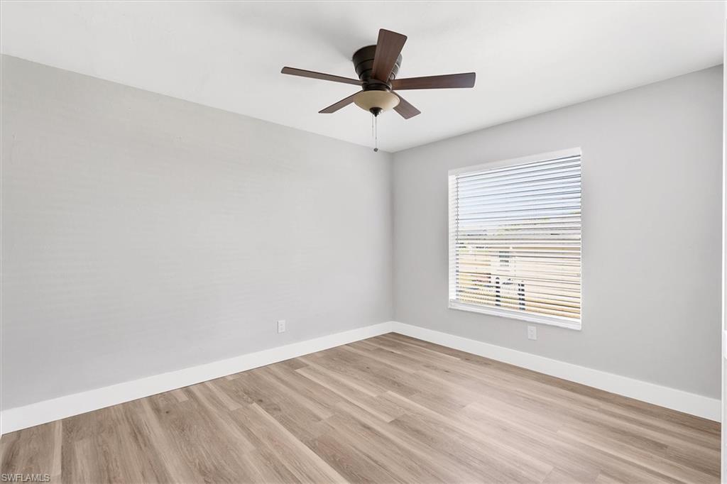 Unfurnished room with light wood-style floors and a ceiling fan