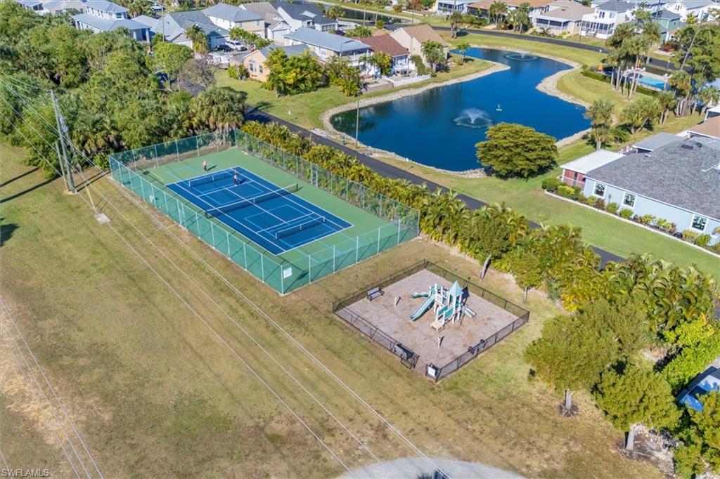 Aerial perspective of suburban area featuring a nearby body of water