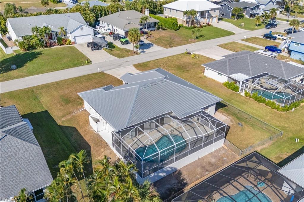 Aerial perspective of suburban area featuring a pool