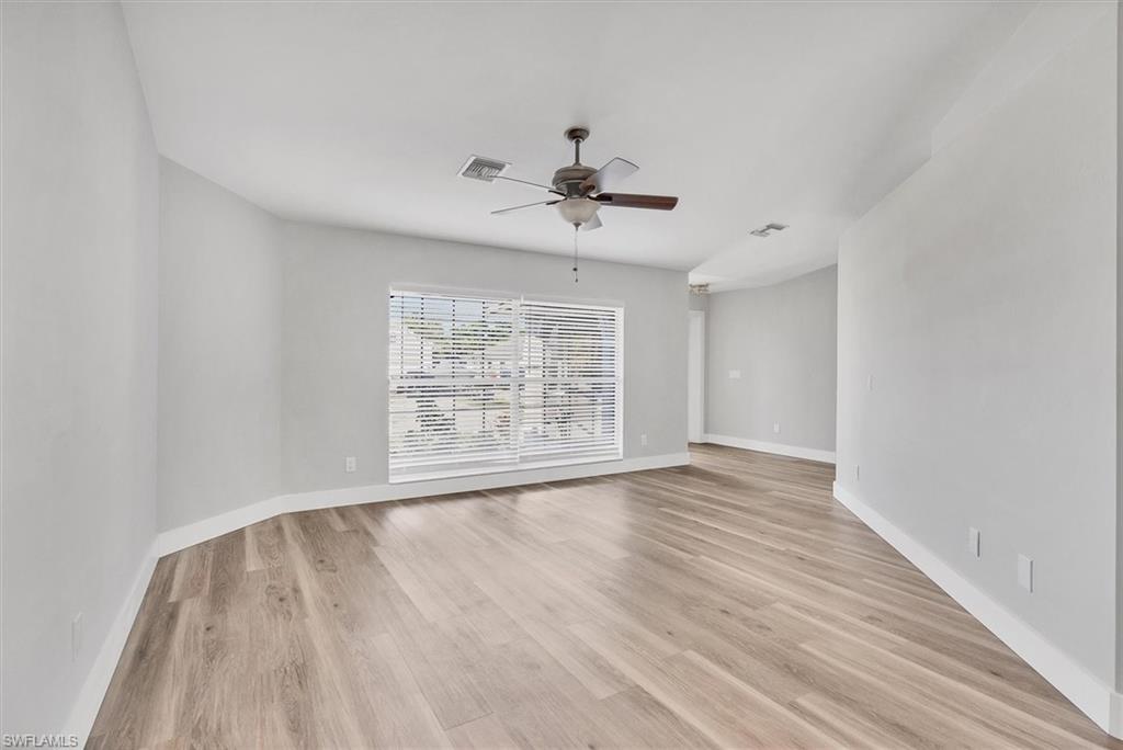 Empty room featuring light wood-style floors and ceiling fan