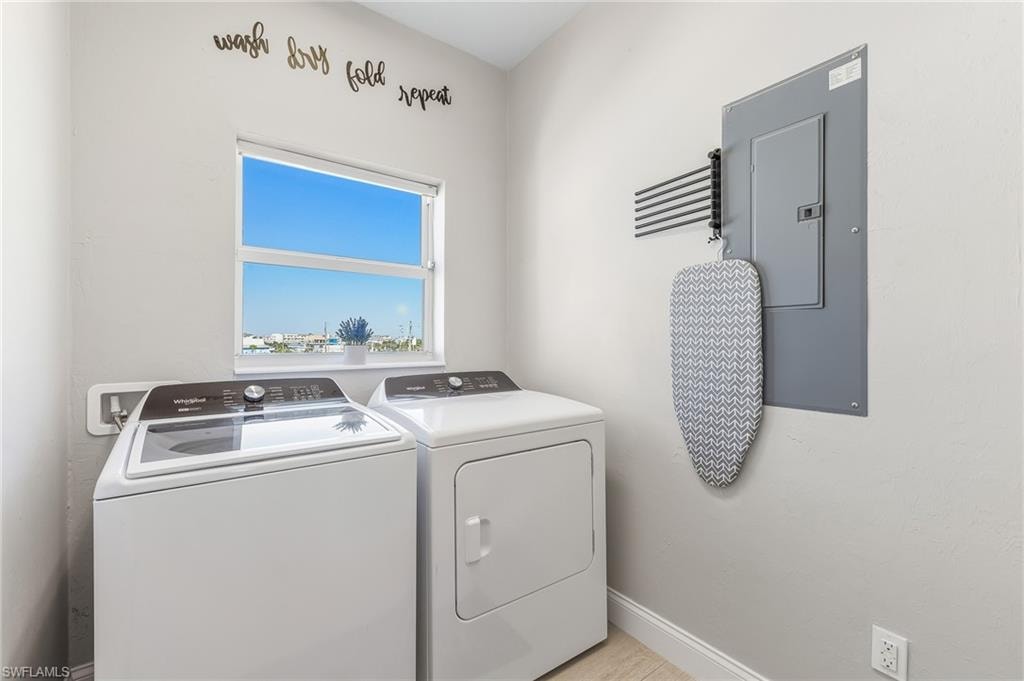 Washroom with electric panel and washer and dryer
