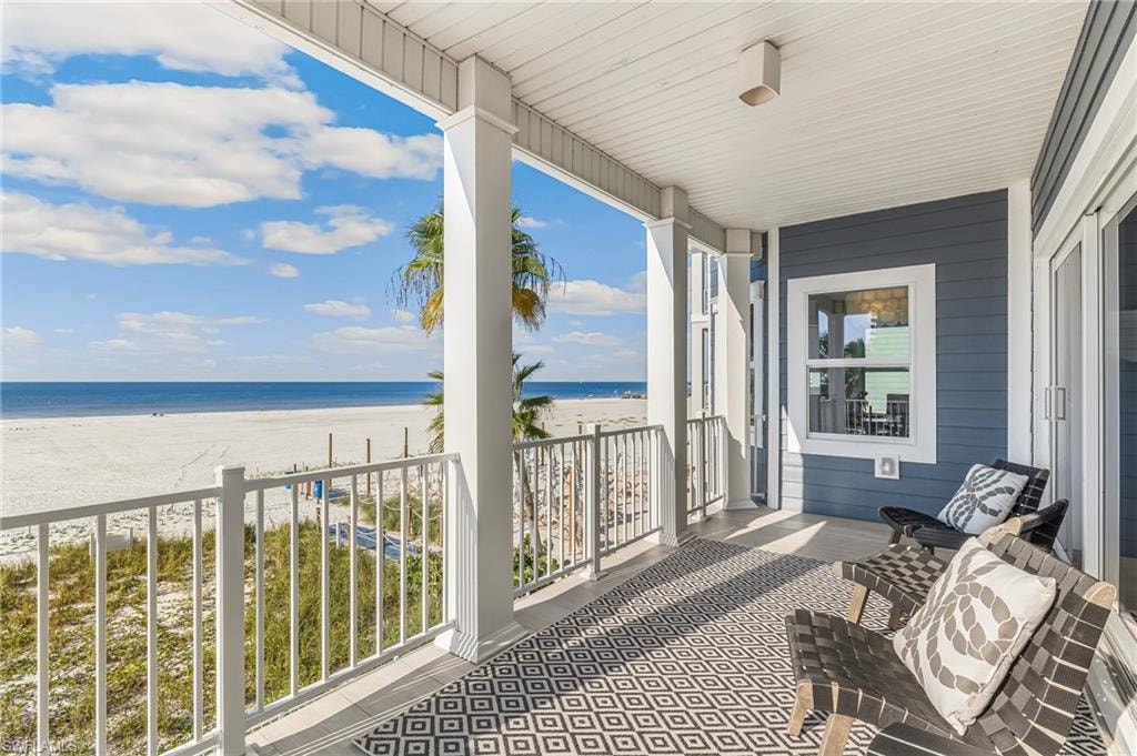 Balcony with view of water and beach