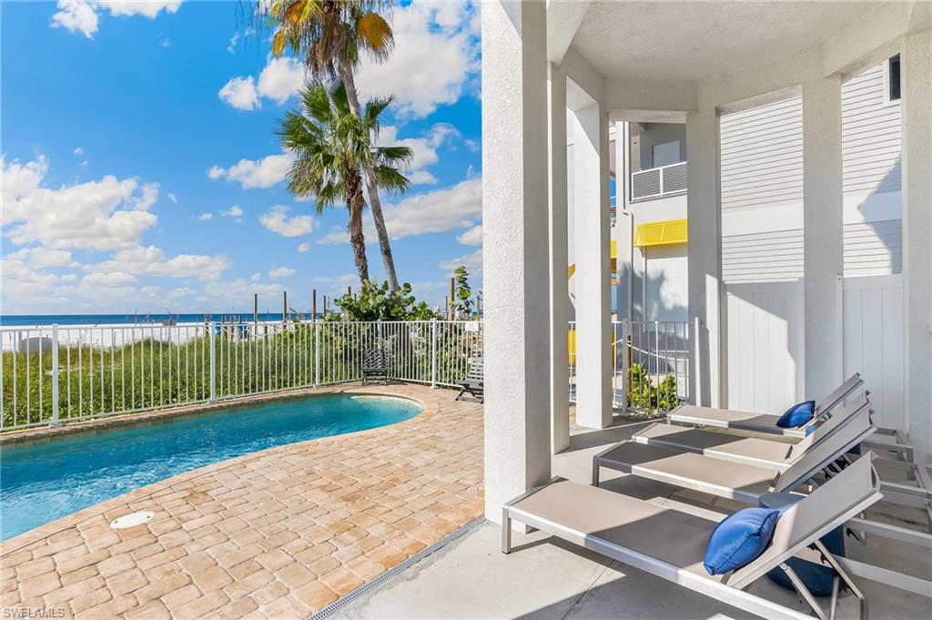 View of pool with a patio and a water view