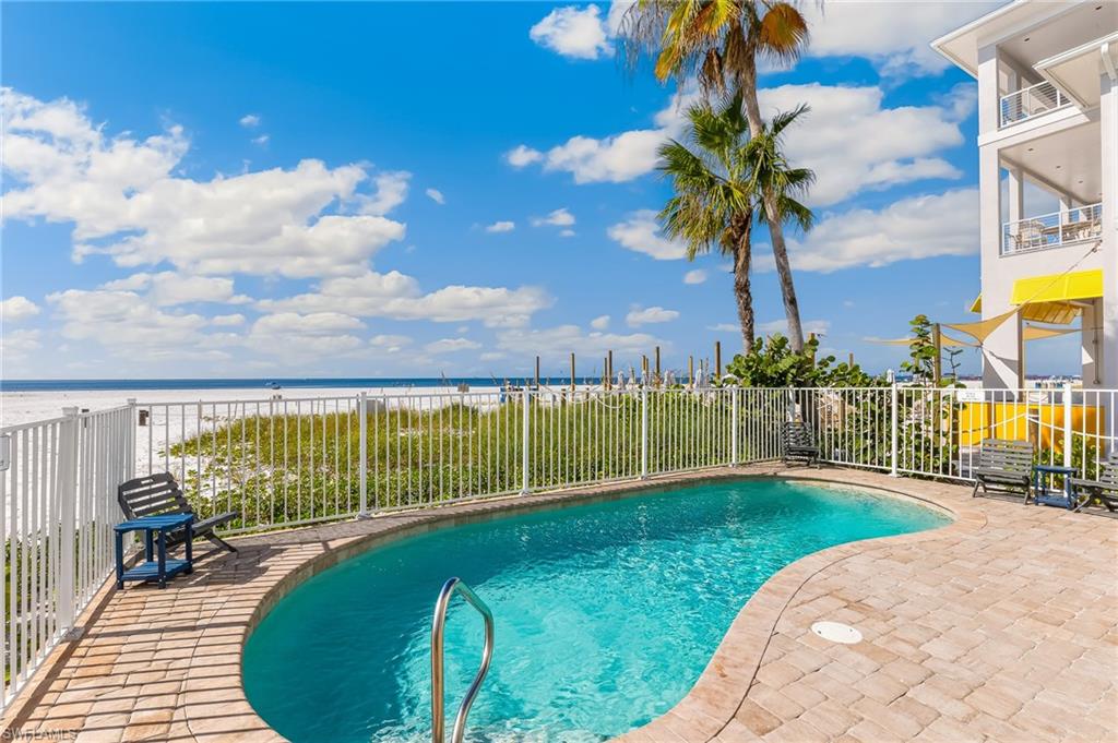 View of pool with a water view and a patio