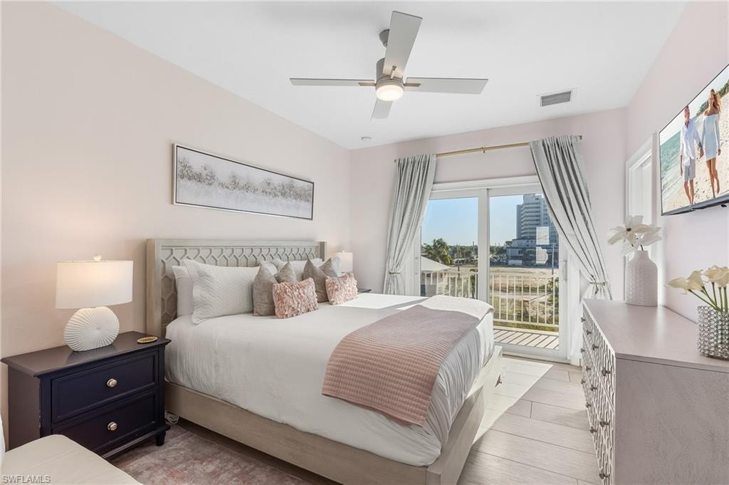 Bedroom with access to exterior, light wood finished floors, and a ceiling fan
