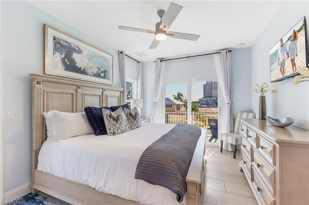 Bedroom featuring ceiling fan, access to outside, and light wood finished floors