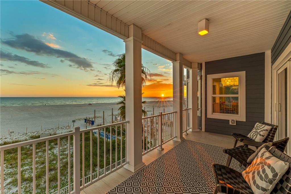 Balcony with view of water and beach
