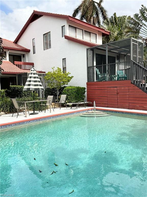 Pool with sitting area and BBQ grill.  Exit back of unit via he screened lanai and you are at the pool.