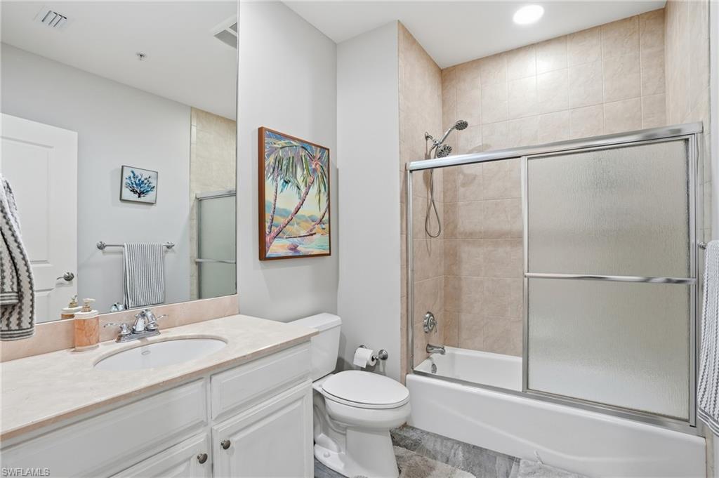 Full bath featuring vanity and enclosed tub / shower combo - Virtually Edited Image